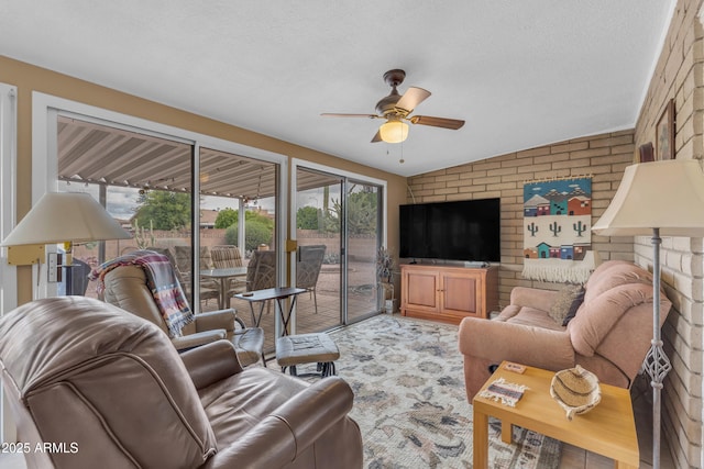 living area with carpet, brick wall, a ceiling fan, and a sunroom