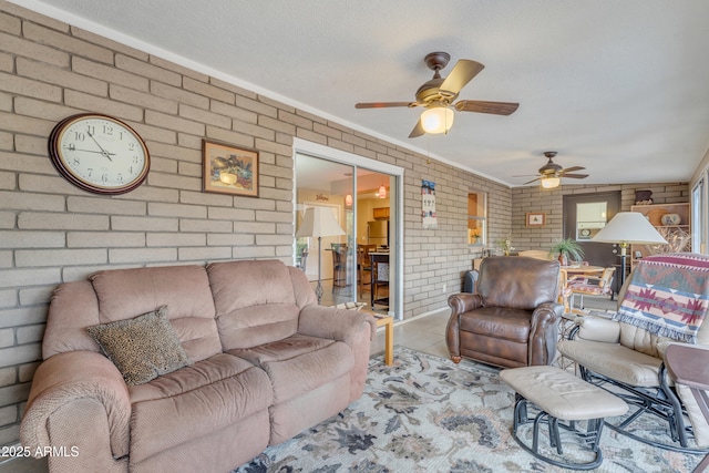 tiled living area featuring brick wall and ceiling fan