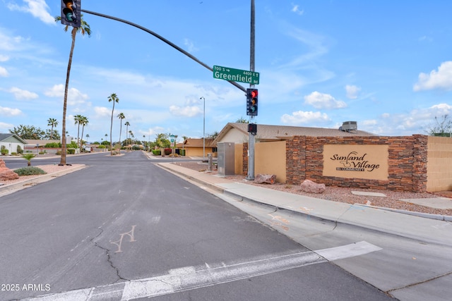 view of street featuring sidewalks, curbs, and traffic lights