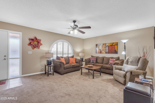 living area with light carpet, baseboards, a textured ceiling, and ceiling fan