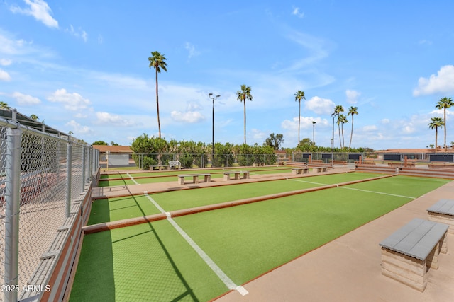 view of home's community featuring fence