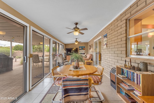 sunroom featuring ceiling fan