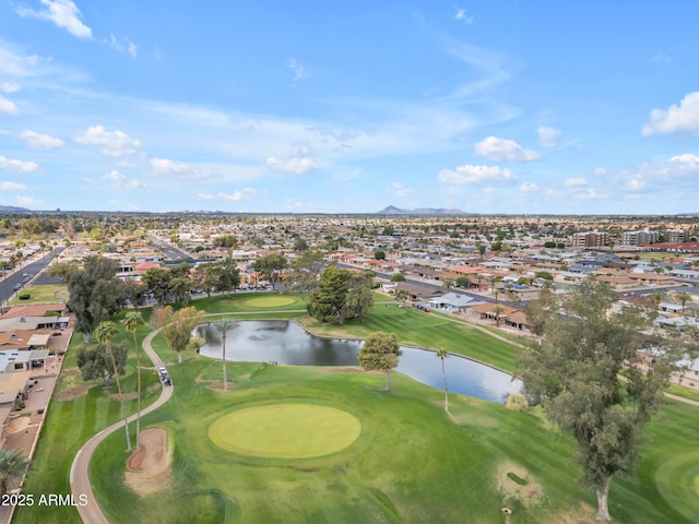 birds eye view of property with a water view and golf course view