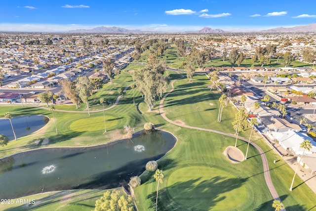 aerial view featuring view of golf course, a residential view, and a water and mountain view