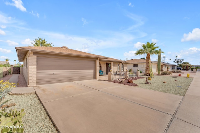 single story home featuring brick siding, driveway, and fence