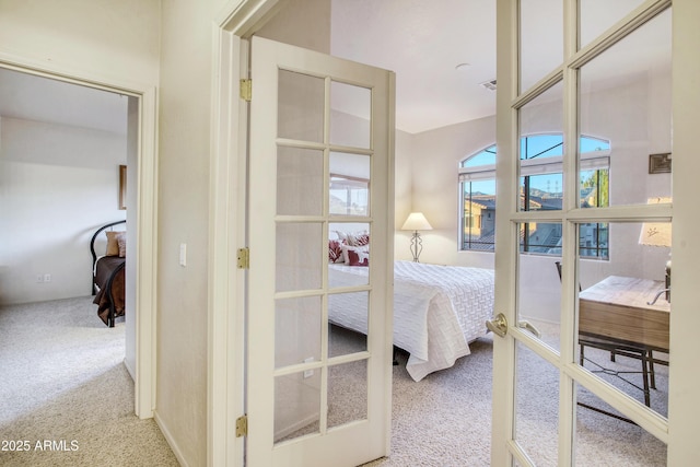 carpeted bedroom with french doors