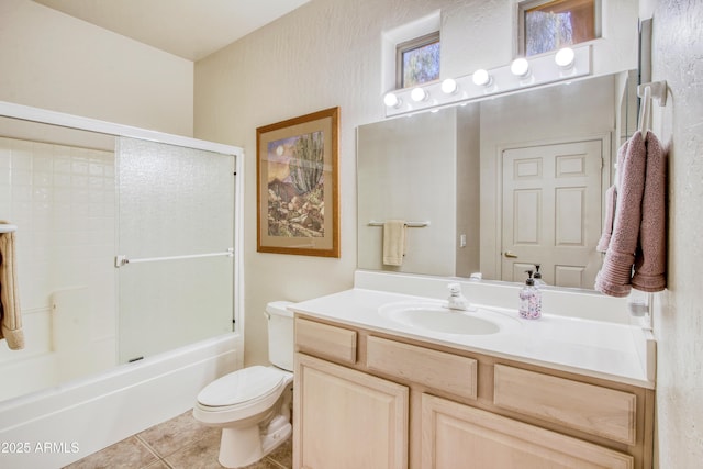 full bathroom with tile patterned flooring, vanity, shower / washtub combination, and toilet