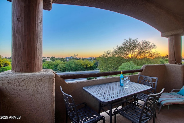 view of balcony at dusk