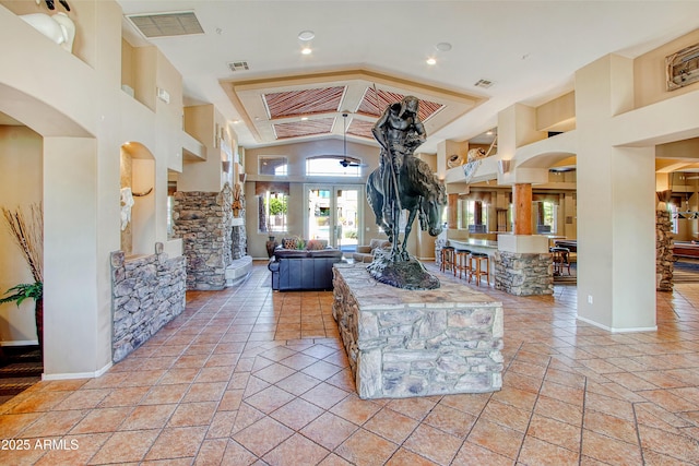 interior space with beam ceiling, high vaulted ceiling, and light tile patterned flooring