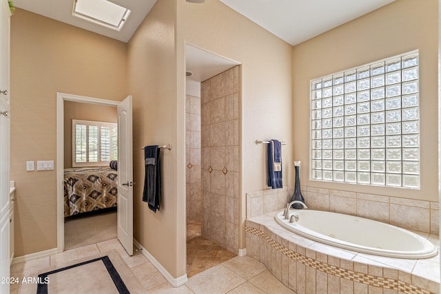 bathroom with tile patterned flooring and shower with separate bathtub