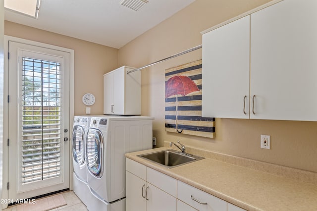 laundry room with washer and dryer, sink, light tile patterned floors, and cabinets