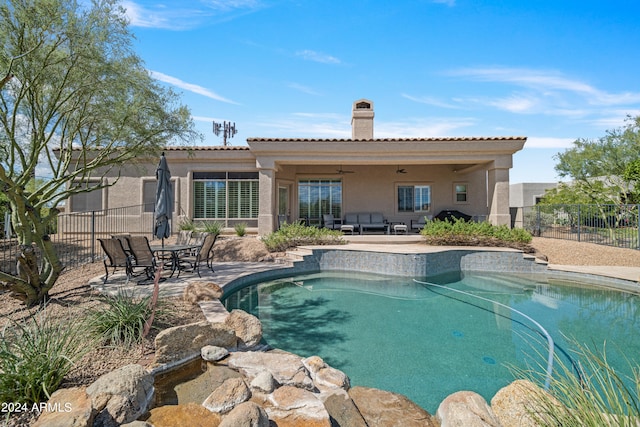 view of pool with ceiling fan and a patio