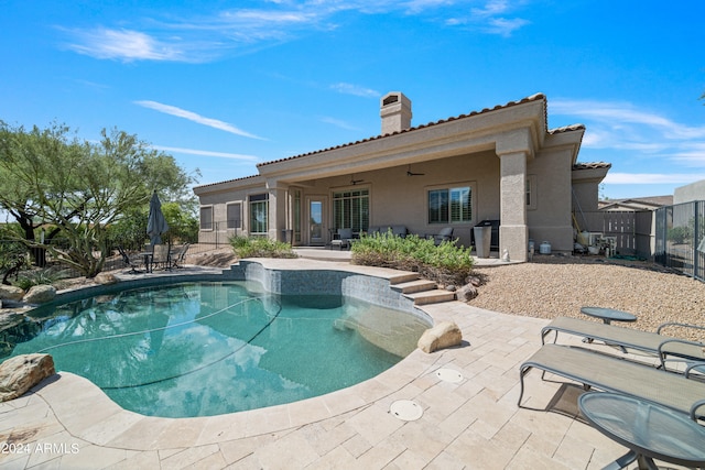 view of swimming pool featuring a patio and ceiling fan