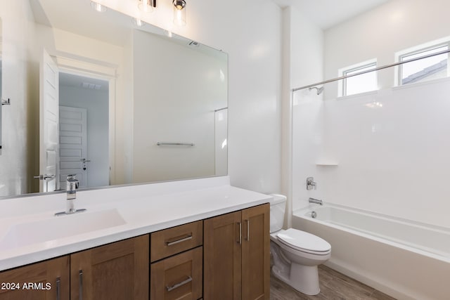 full bathroom with vanity, toilet, wood-type flooring, and shower / washtub combination