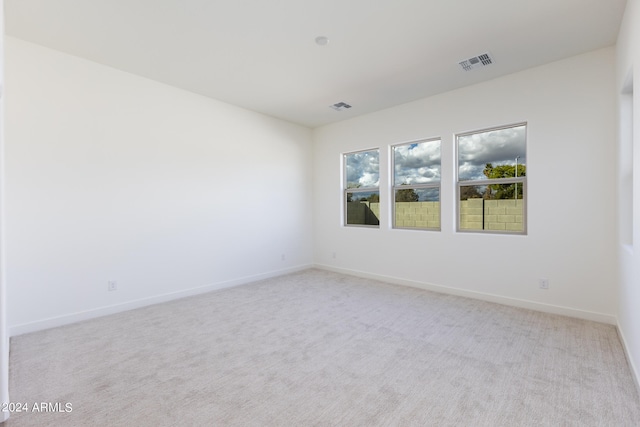 unfurnished room with light colored carpet