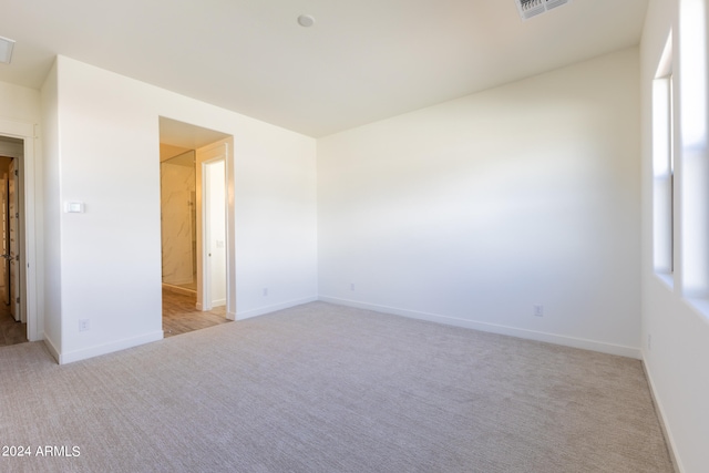 empty room featuring light colored carpet