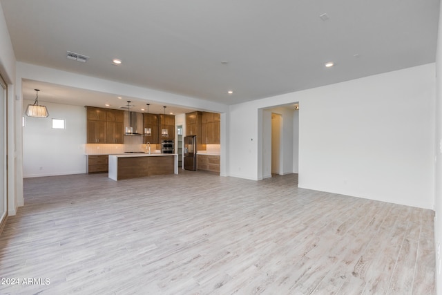 unfurnished living room with light hardwood / wood-style floors