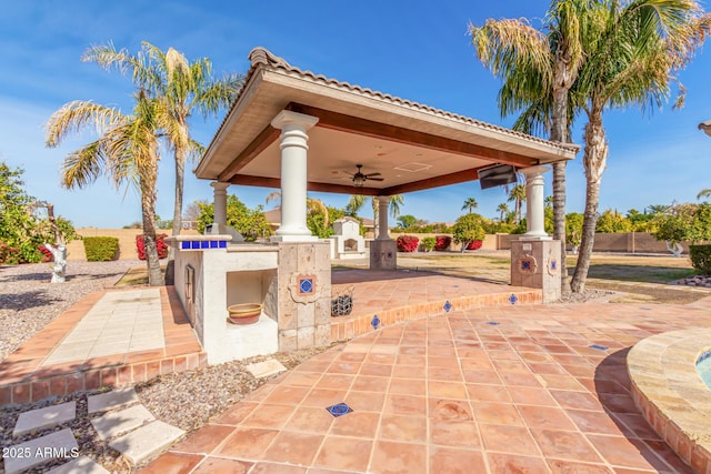 view of patio / terrace with a gazebo, ceiling fan, an outdoor kitchen, and an outdoor bar