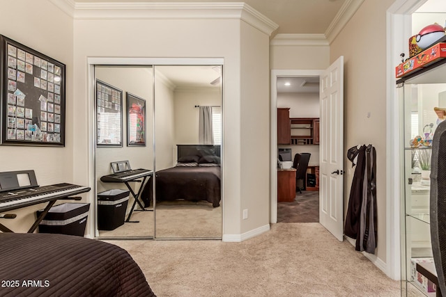 carpeted bedroom with ornamental molding and a closet