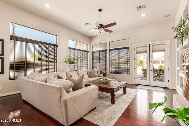 living room featuring dark hardwood / wood-style flooring, french doors, and ceiling fan