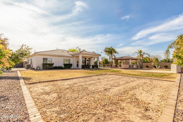 view of front of home with a gazebo and central AC