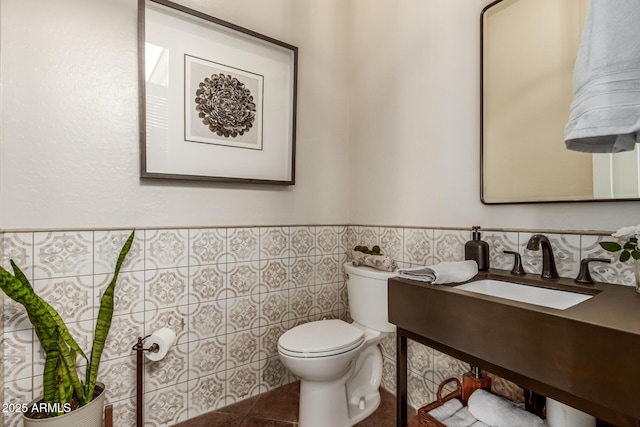 bathroom featuring tile patterned flooring, vanity, tile walls, and toilet