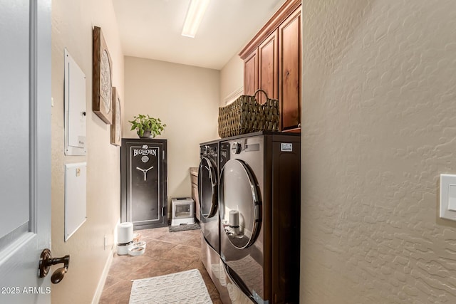 washroom with cabinets, washing machine and clothes dryer, and light tile patterned flooring