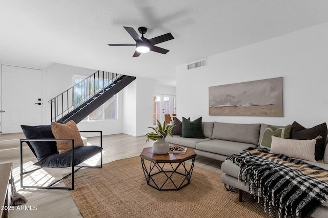 living room with ceiling fan and light wood-type flooring