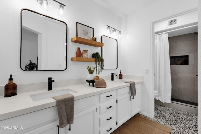 bathroom with a shower with curtain, vanity, and toilet