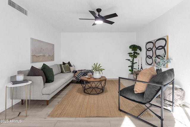 living room featuring ceiling fan and light wood-type flooring