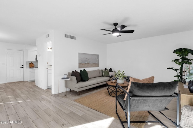 living room with ceiling fan and light hardwood / wood-style floors