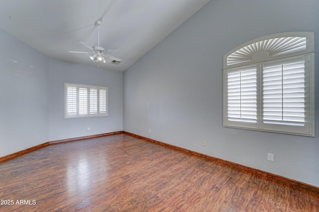 empty room featuring baseboards, wood finished floors, a ceiling fan, and vaulted ceiling