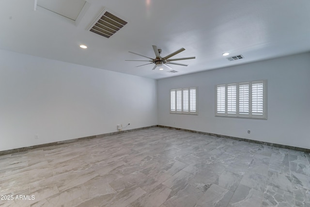 spare room featuring visible vents, baseboards, and ceiling fan