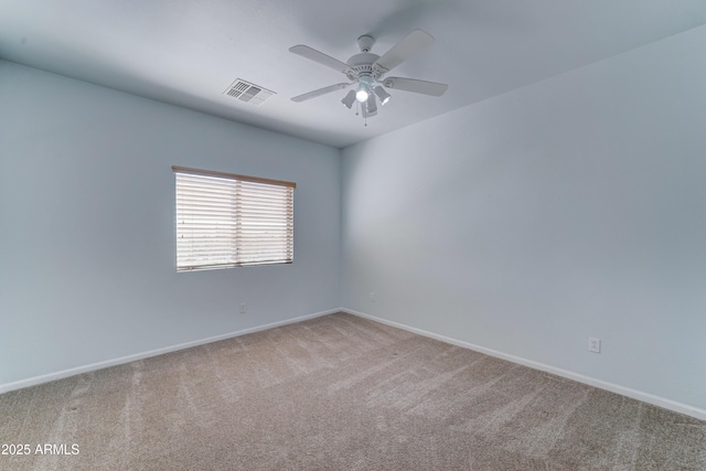 carpeted empty room with baseboards, visible vents, and ceiling fan