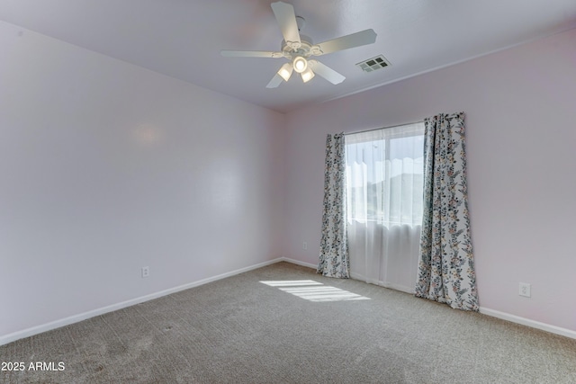 unfurnished room featuring visible vents, baseboards, carpet flooring, and a ceiling fan