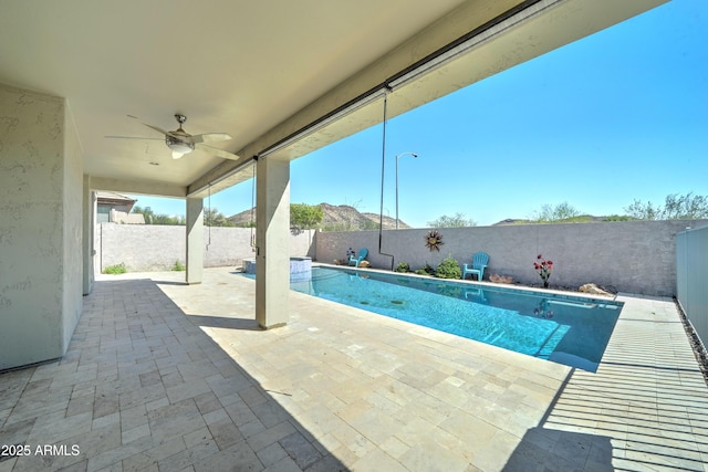 view of swimming pool with a patio area, ceiling fan, a fenced backyard, and a fenced in pool