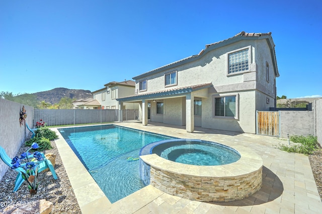 view of swimming pool featuring a patio area, a mountain view, a fenced backyard, and a fenced in pool