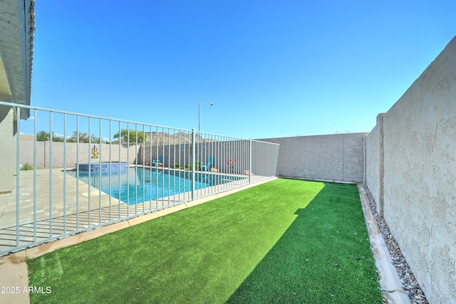 view of swimming pool featuring a fenced in pool, a lawn, and a fenced backyard