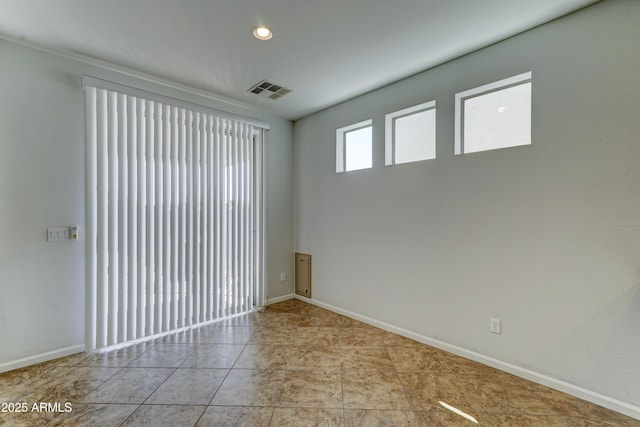 tiled spare room featuring recessed lighting, visible vents, and baseboards