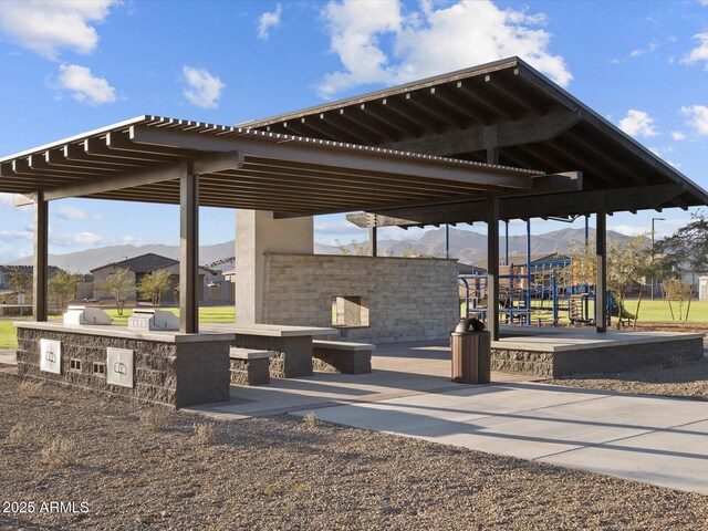 view of property's community with exterior kitchen and a mountain view