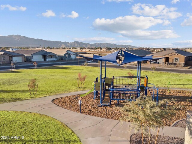 exterior space featuring a yard, a residential view, and a mountain view