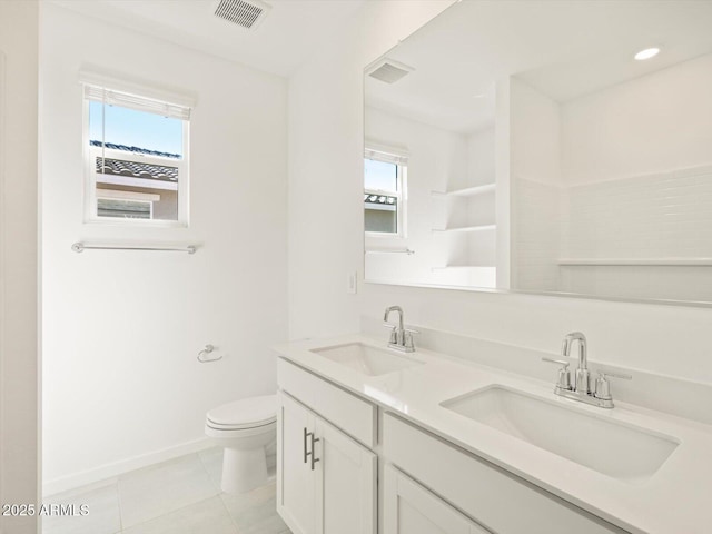 bathroom featuring tile patterned flooring, visible vents, a sink, and toilet