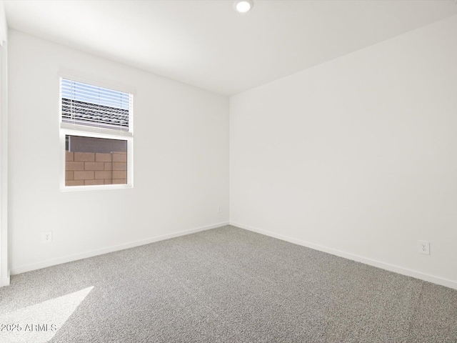 empty room with carpet floors, recessed lighting, and baseboards