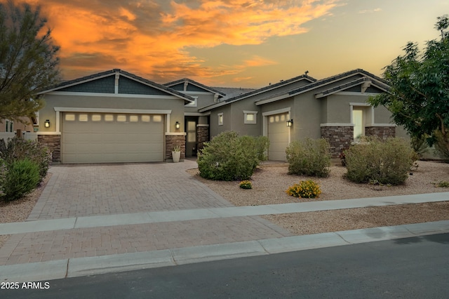 2513 E Pleasant Ln, Phoenix, AZ 85042 - craftsman house with stone siding, stucco siding, a garage, and decorative driveway