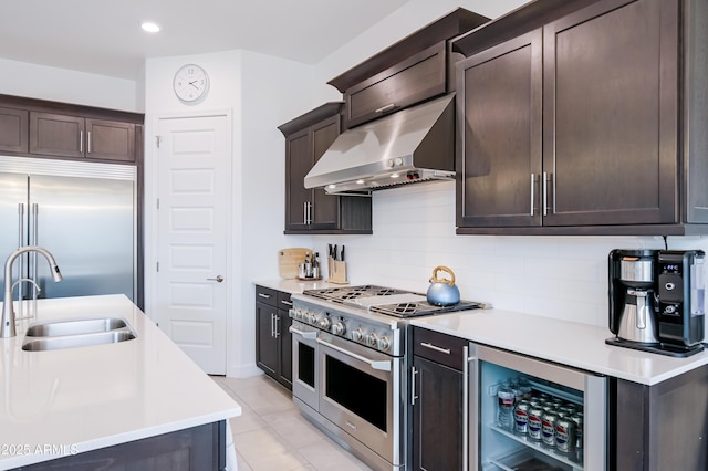 2513 E Pleasant Ln, Phoenix, AZ 85042 - kitchen with high quality appliances, under cabinet range hood, a sink, beverage cooler, and light countertops