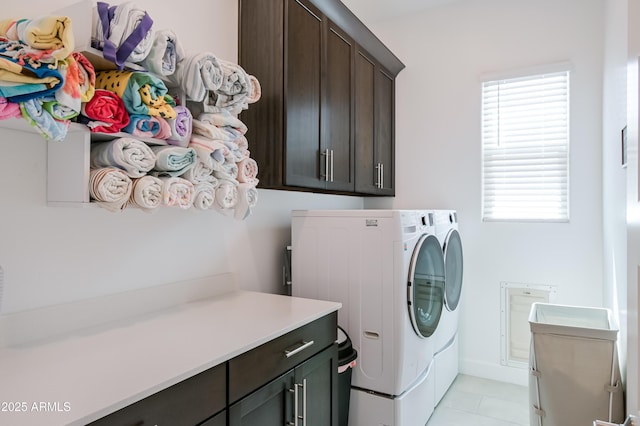 2513 E Pleasant Ln, Phoenix, AZ 85042 - laundry area featuring separate washer and dryer, cabinet space, healthy amount of natural light, and light tile patterned flooring
