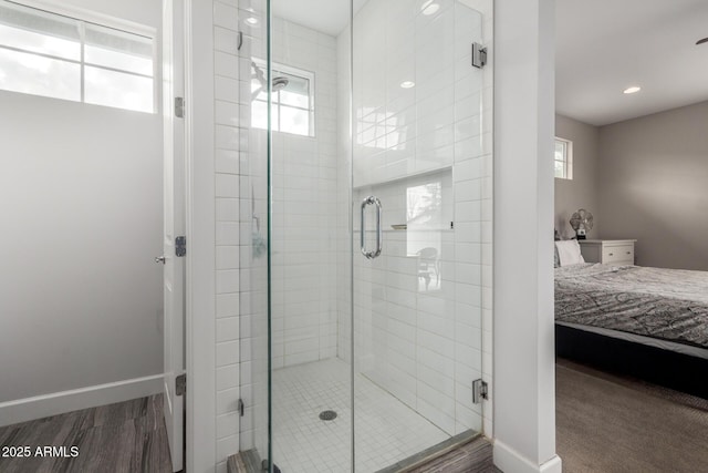 bathroom featuring wood-type flooring, plenty of natural light, and walk in shower