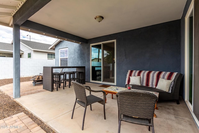 view of patio / terrace with an outdoor living space with a fire pit