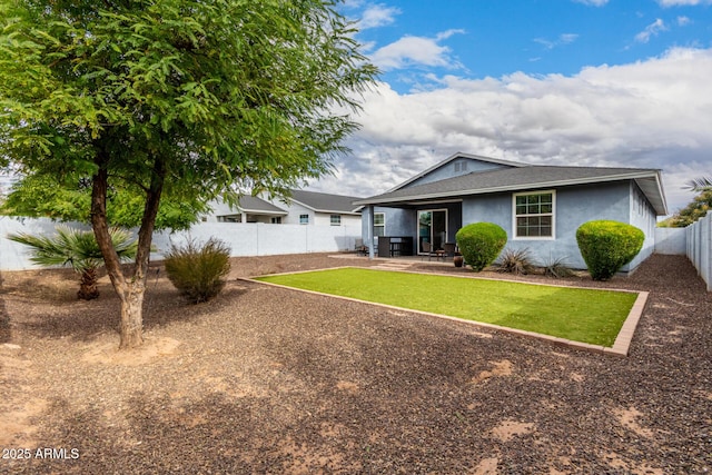 rear view of property with a patio area and a lawn