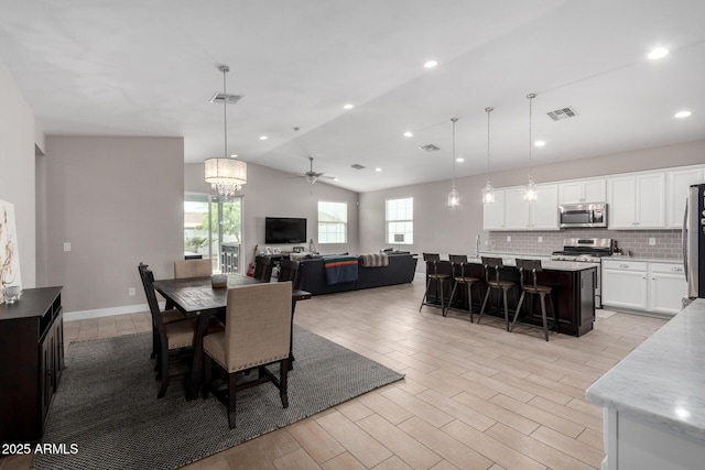 dining room featuring ceiling fan and lofted ceiling